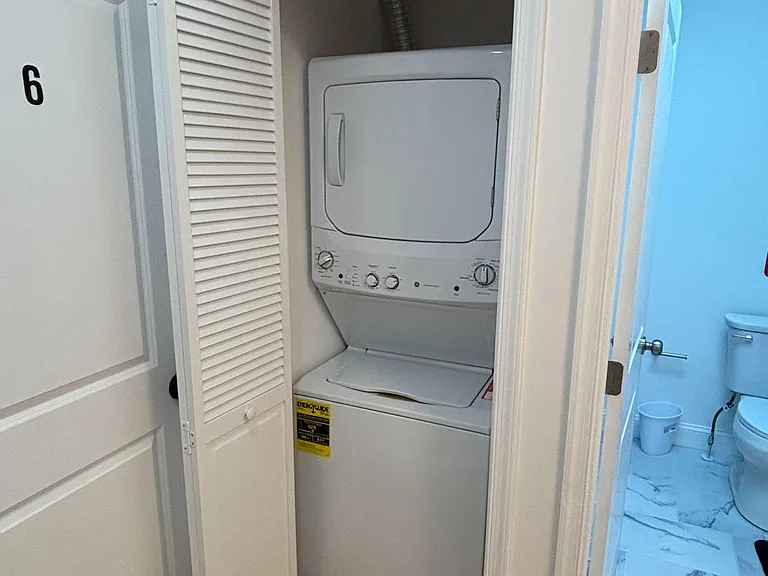 In-home stacked washer and dryer tucked into a dedicated closet for convenient laundry access.