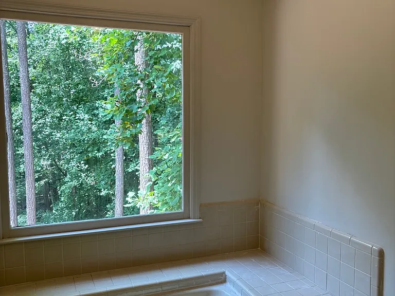 soaking tub with beautiful view of the very private backyard
