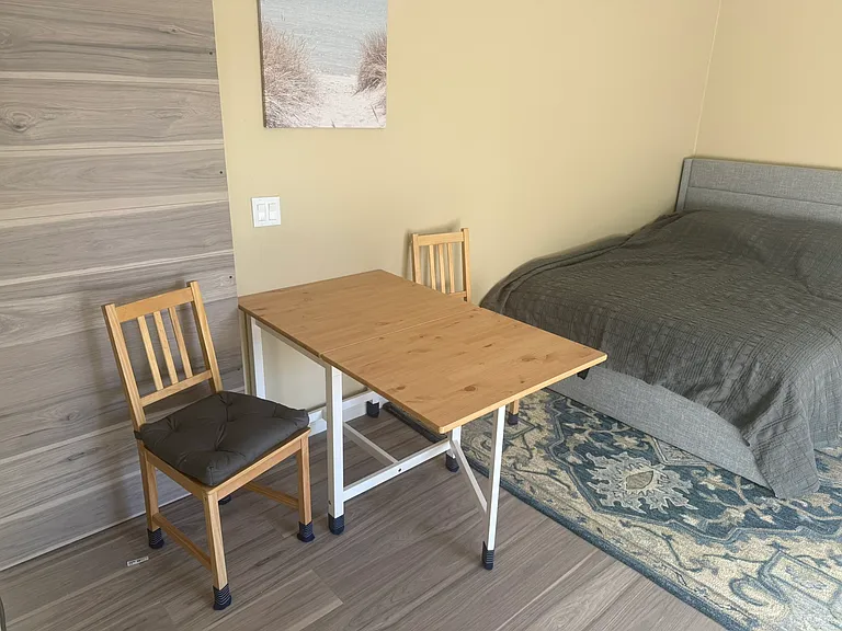 Dining table next to queen size bed