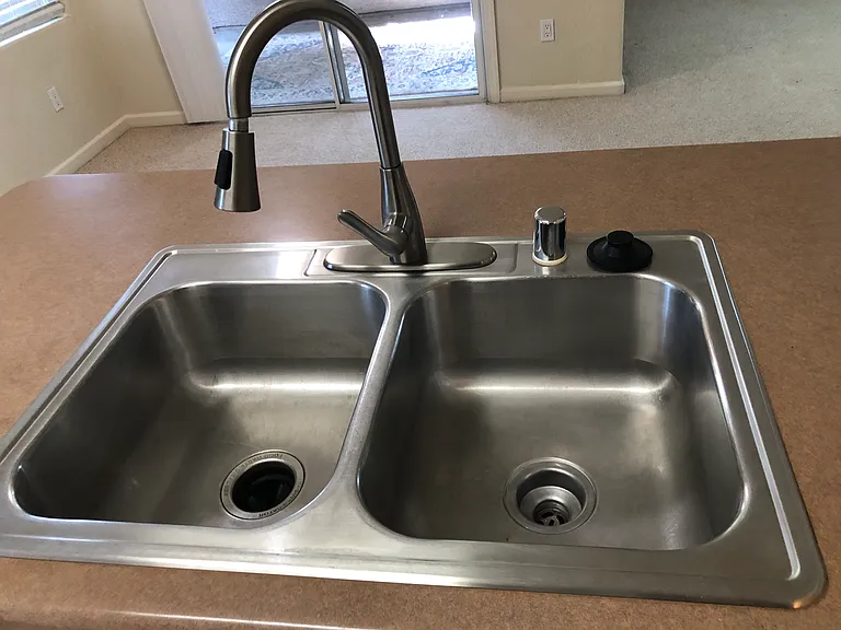 Newer facet, garbage disposal and duel pan sink.