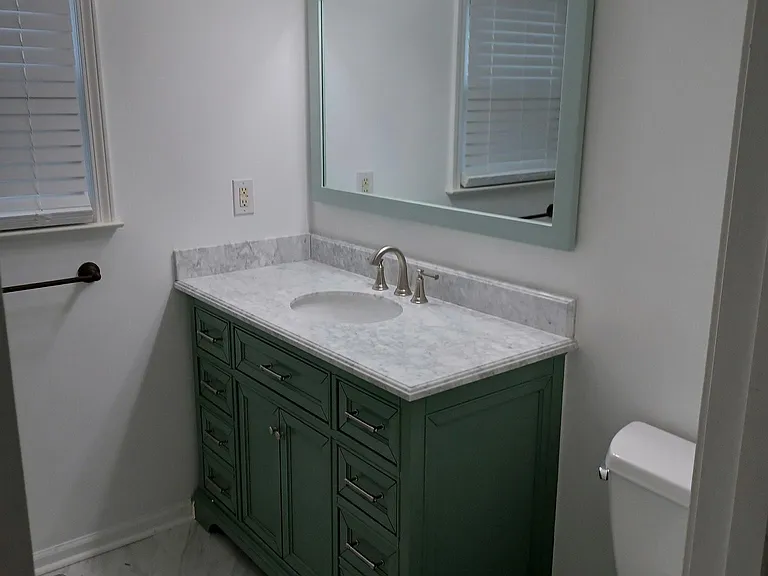 Special order Carrara marble top mint green vanity , new mirror new Carrara marble flooring .