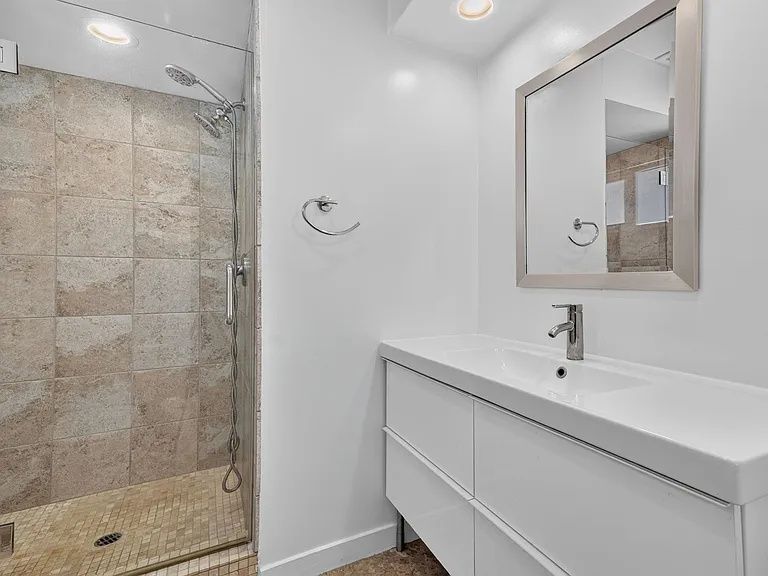 MASTER BATHROOM HAS LARGE DESIGNER TILED SHOWER W/ GLASS DOOR, MODERN VANITY, LOTS OF COUNTERTOP AND CABINET SPACE.