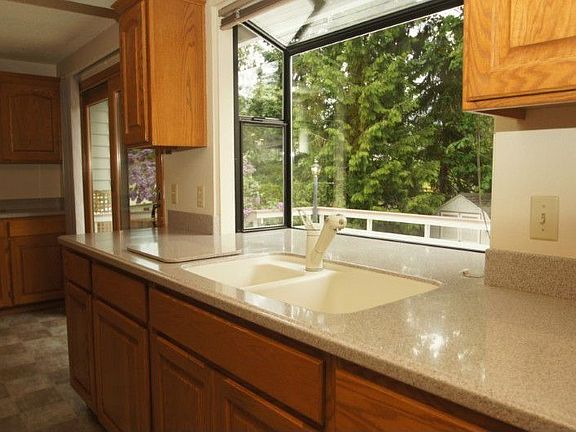 Corian counter tops and garden window in kitchen.