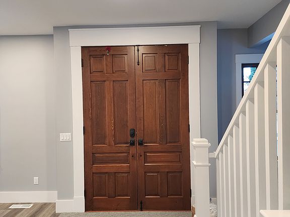 Oversized front doors leading to the front porch. These doors were saved from another historical building adding so much character to this space