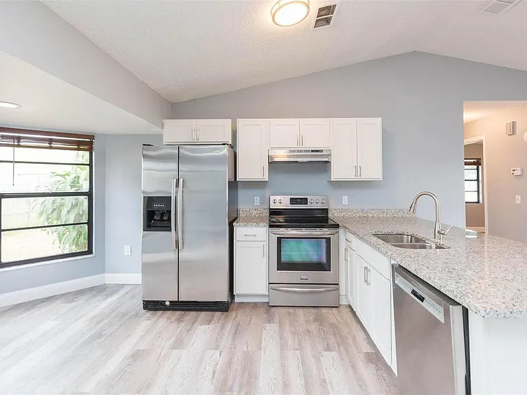 Our kitchen features a dining area and modern appliances, perfect for preparing and enjoying home-cooked meals.