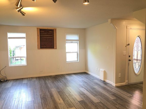The downstairs living room offers an open, airy feel with ample natural light.