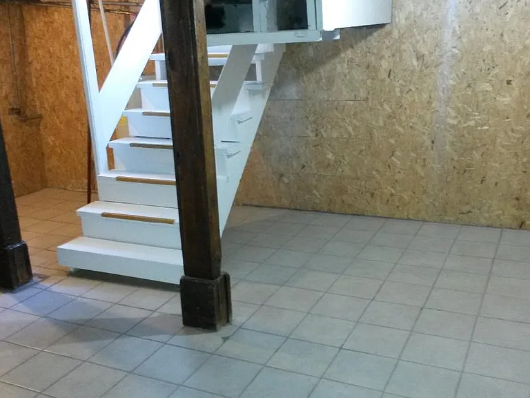 Basement stair case safety rail & storage area