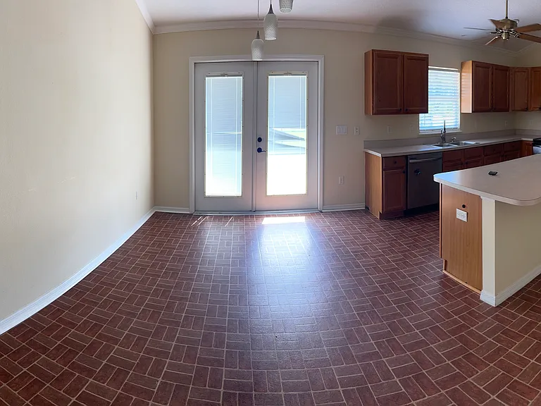 View from left side of living area into dining/kitchen area