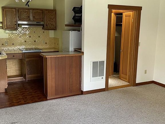 View of kitchen, and hallway to closet and bathroom.