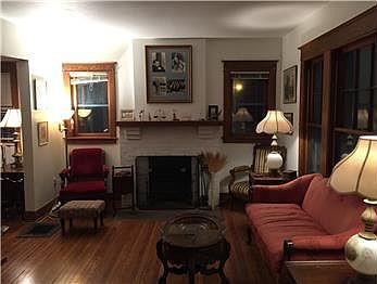 View of the fireplace, wood flooring & vintage furniture