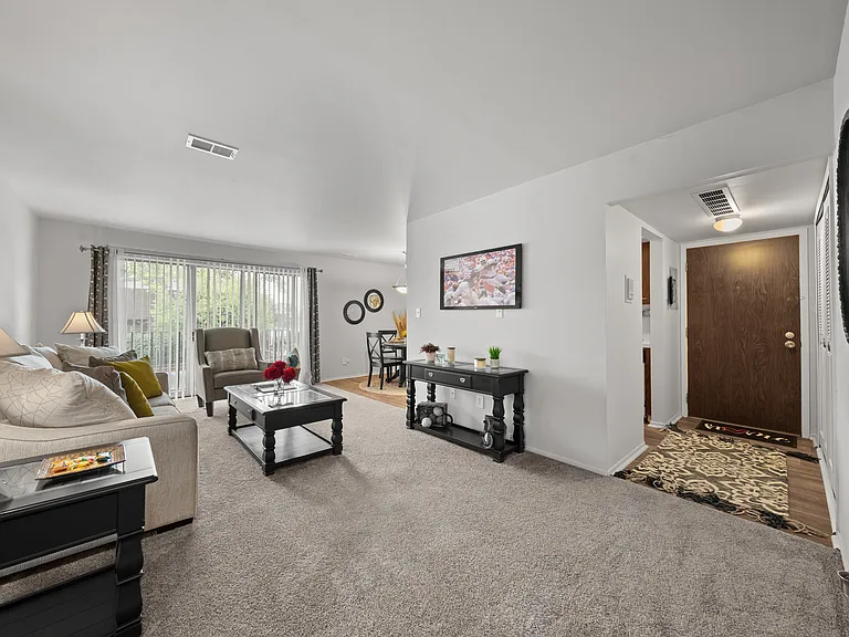 Open and airy living room with natural lighting at Knottingham Apartments in Clinton Township, MI.