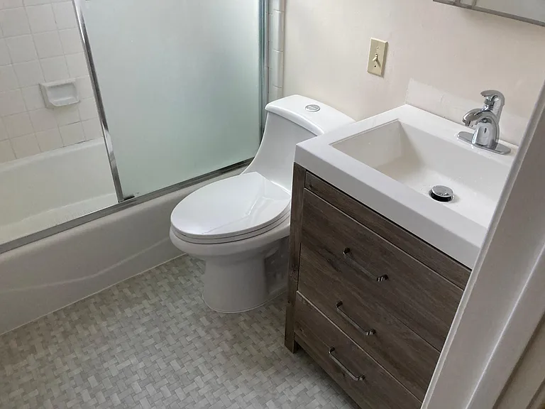 new toilet and sink and vanity in bathroom
