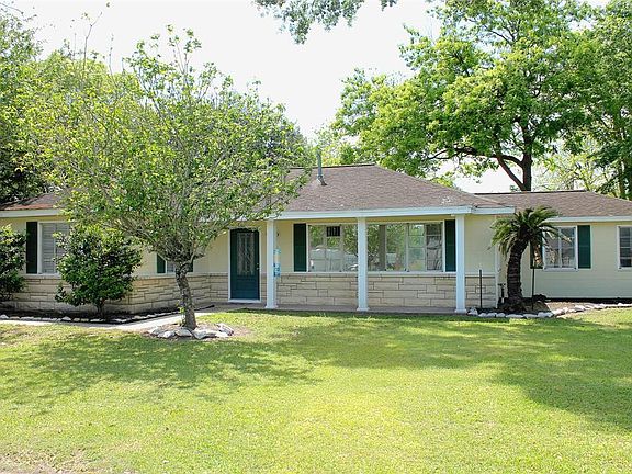 The quaint ranch style home offers a large covered patio and beautiful landscape in the spacious front yard.