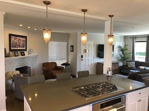 Front door, fireplace, and living area from the kitchen