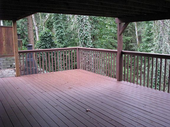Lower deck overlooking a green belt with a year round creek at the bottom.