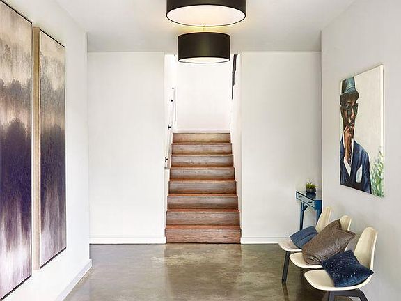Front Foyer entrance to house. To the left is a hallway that leads to the mini master suite, perfect for in-laws and extra family or friends. 

Stairway leads up to the main level of the home.