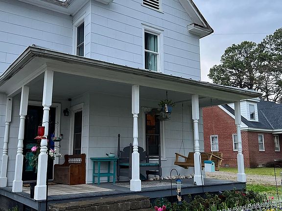 Front porch with covered patio and porch swing.