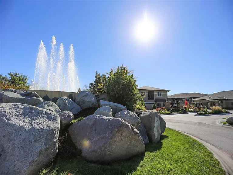 A peaceful fountain and scenic surroundings set the tone for a serene living experience.