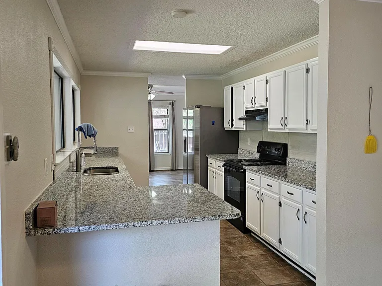 Breakfast area looking in to kitchen with granite counters
