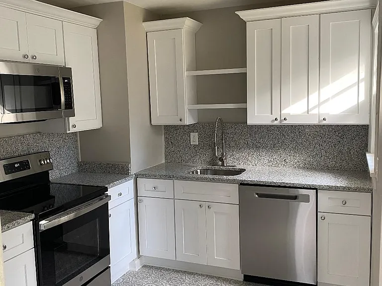Brand new kitchen with granite counters and stainless steel appliances