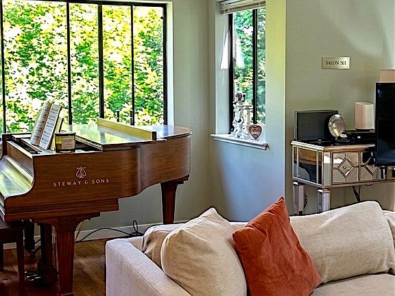 Living room: vaulted ceilings, tract lighting, hardwood floor & wood burning fireplace.