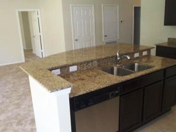 Kitchen looks onto family room.
