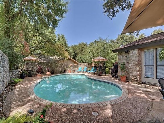Private yard with POOL and stone wall surround.