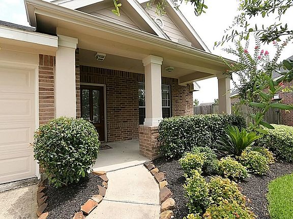 Pretty landscaping and sprinkler front and back.