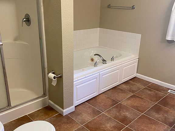 Jetted tub with separate shower