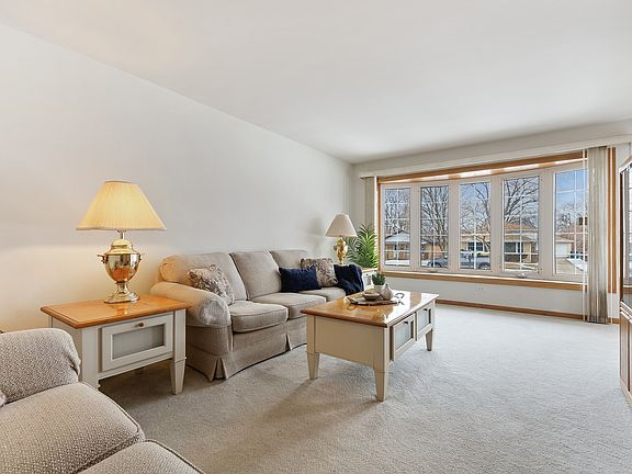 Spacious living room with sunny bay window.