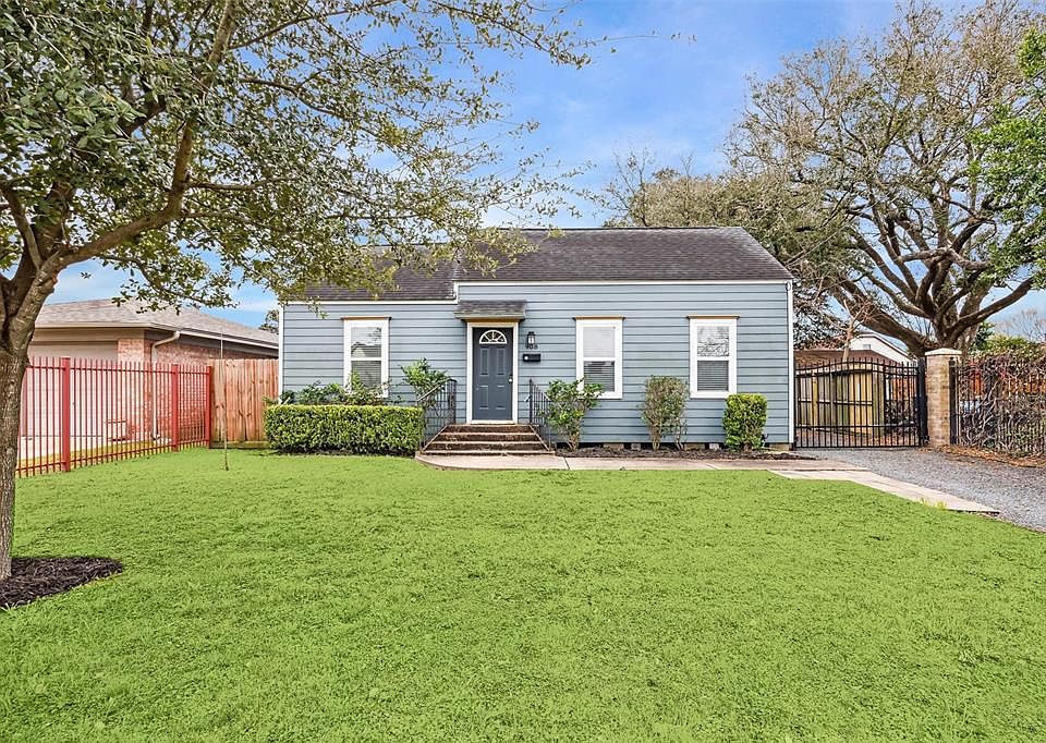 Charming single-story home with a neatly landscaped front yard and mature trees. Features a welcoming front porch, a gated driveway, and a fenced backyard, offering both privacy and curb appeal.