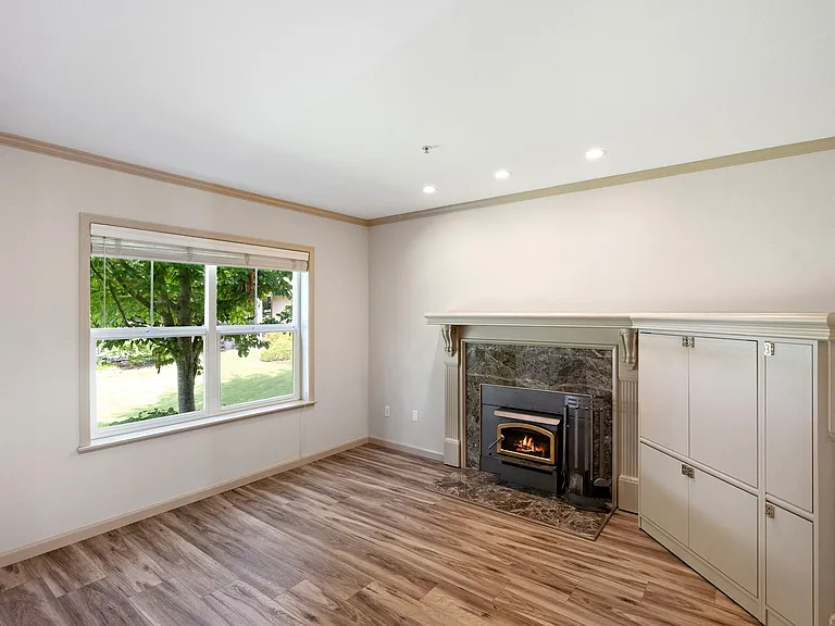 Cozy wood-burning fireplace and built-in storage in downstairs living area.