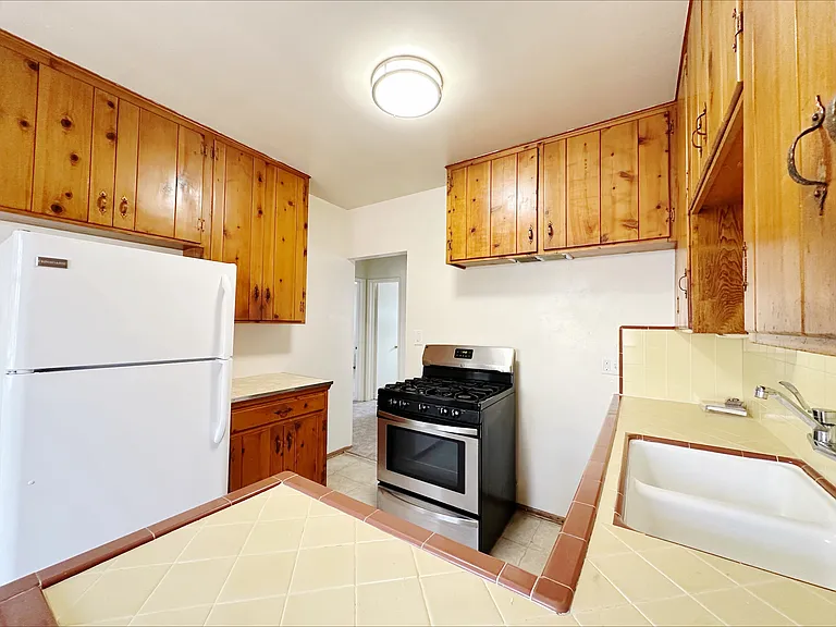 Kitchen is ideal with a walk thru layout and features a gas-range stove with a 5th middle burner!