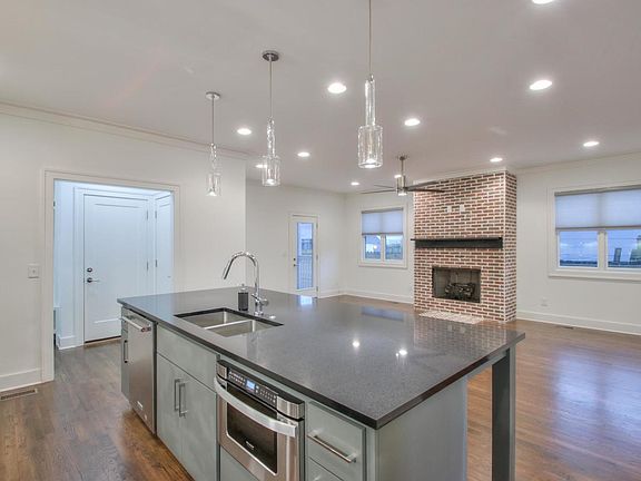 Island equipped with dishwasher, sink, microwave, and lots of storage