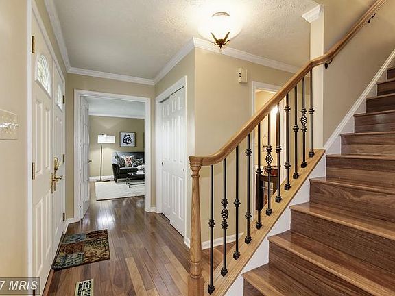 Wide-plank hardwoods and iron balusters