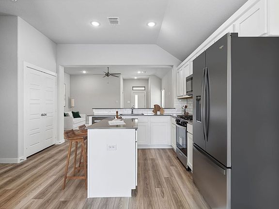 Kitchen in the Amber home plan by Trophy Signature Homes - REPRESENTATIVE PHOTO