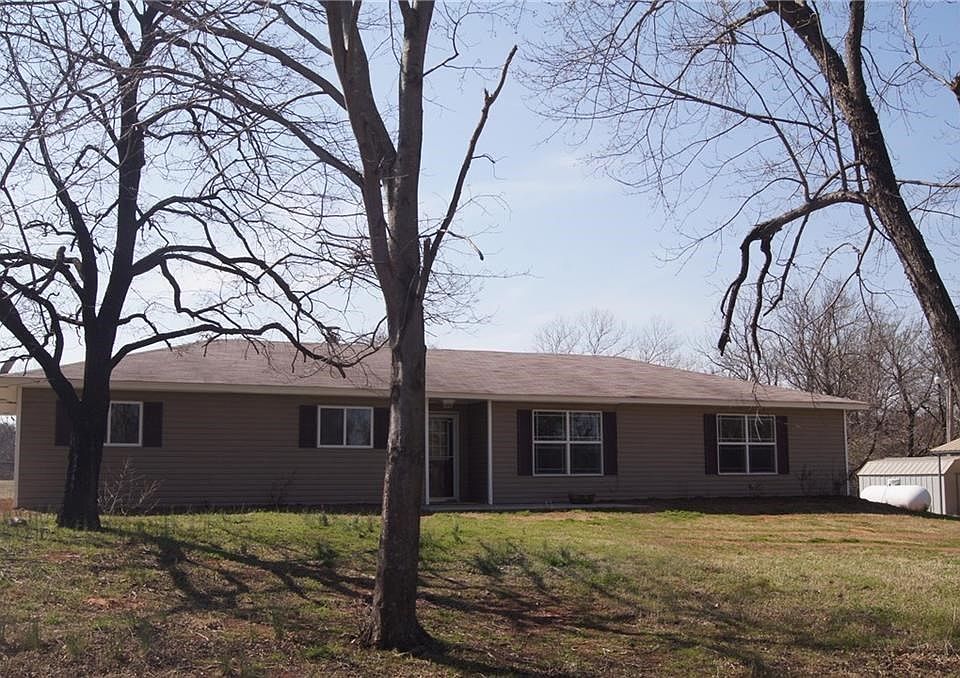 Beautiful with large trees in front and creek in back pasture. Fresh paint, throughout, new carpet in spacious master bedroom.  Large open kitchen features granite counters, large walk in pantry and tile floors. Open to the front part of house and lovely view of back lpasture through French doors. Private Safe room and flex room at the back off patio that can be used for an office, exercise room or bedroom.