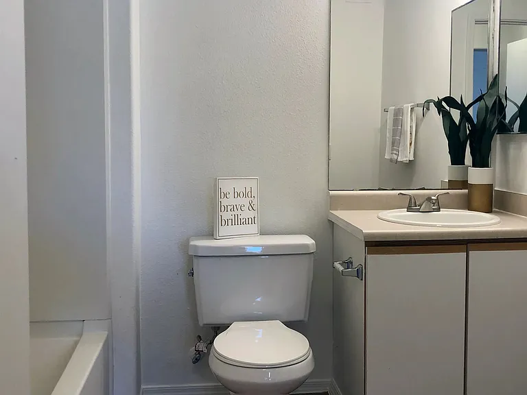 Step into classic-style bathrooms with wood-style flooring, creating an everyday oasis of comfort and privacy.