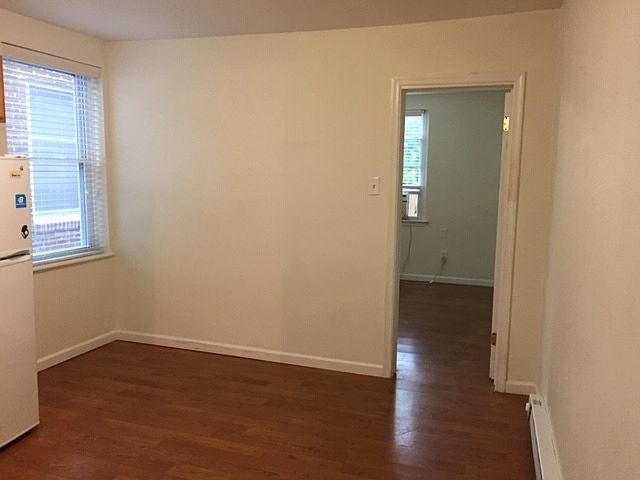 Living space area off kitchen with entry to bedroom