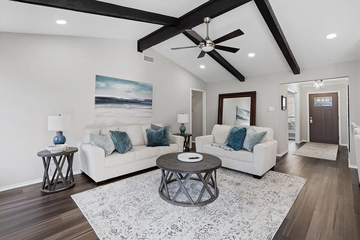 Comfortable main Living Room with Electric Fireplace and Flat Screen TV, Open Concept. Home has Multiple areas to work and relax. Second Living Room at front of the house with workspace. - 401 Innwood Dr
