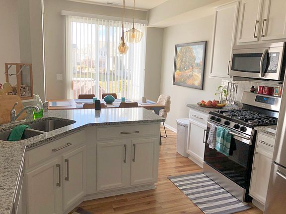 kitchen with 42" tall cabinets, updated appliances and granite countertops