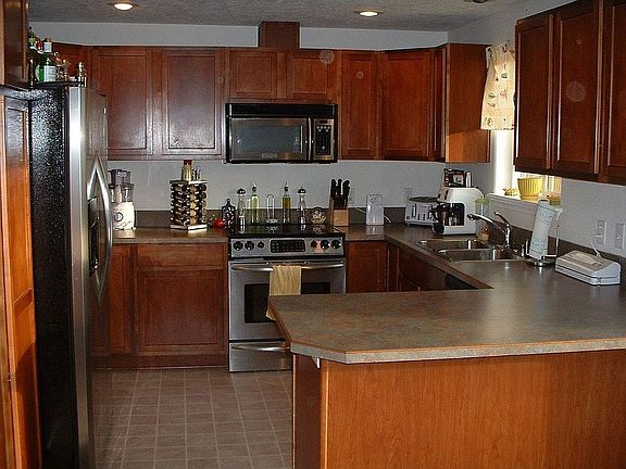 cherry cabinets and stainless appliances