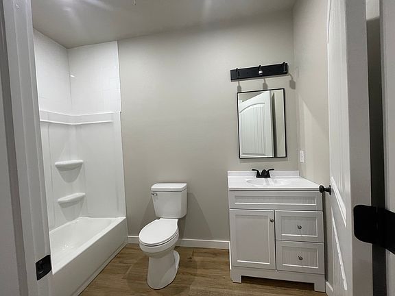 bathroom features a soaking tub / shower combo, single vanity.