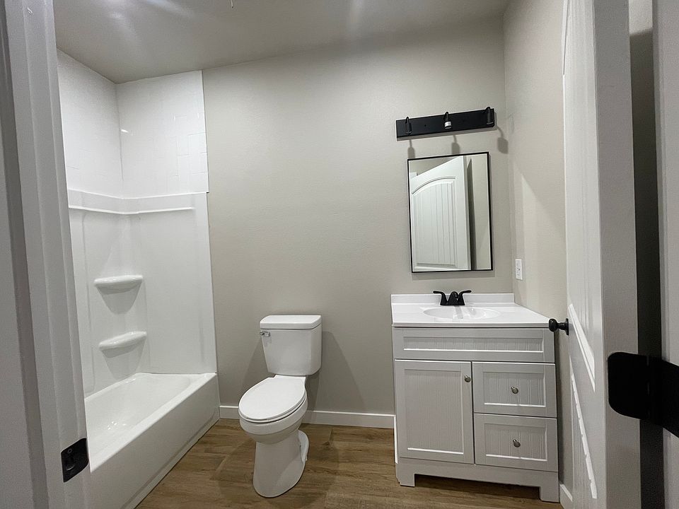 bathroom features a soaking tub / shower combo, single vanity.