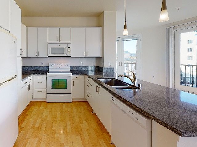 Bright and airy kitchen with granite countertops