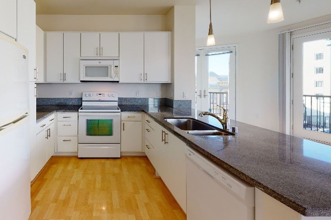 Bright and airy kitchen with granite countertops