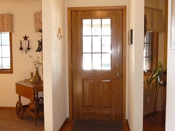 into spacious foyer w/wood fls