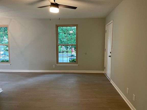 New luxury vinyl floors throughout the unit. View of living room with elegant new ceiling fan.
