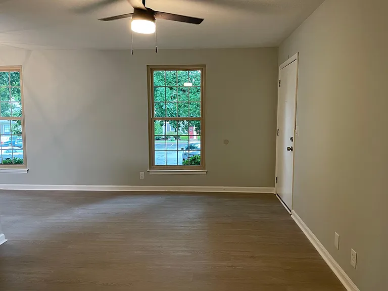 Luxury vinyl floors throughout the unit. View of living room with elegant ceiling fan.