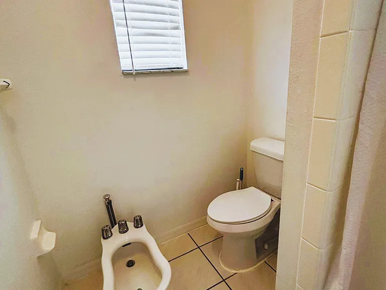 Immaculate toilet area with essential amenities for your comfort.